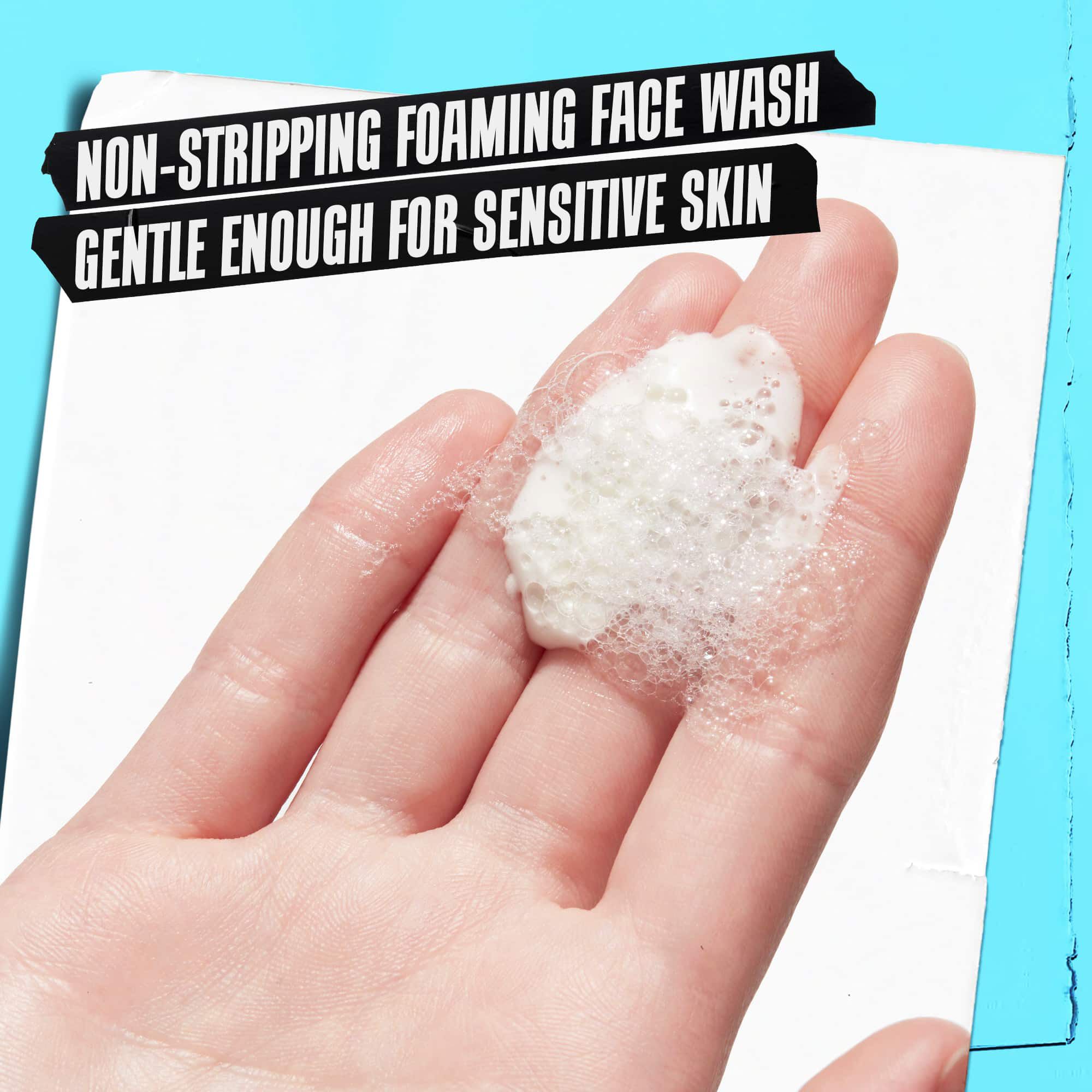 A hand holding Ultra Facial Oil-Free Cleanser foam labeled "Non-Stripping Foaming Free Wash Gentle Enough for Sensitive Skin."