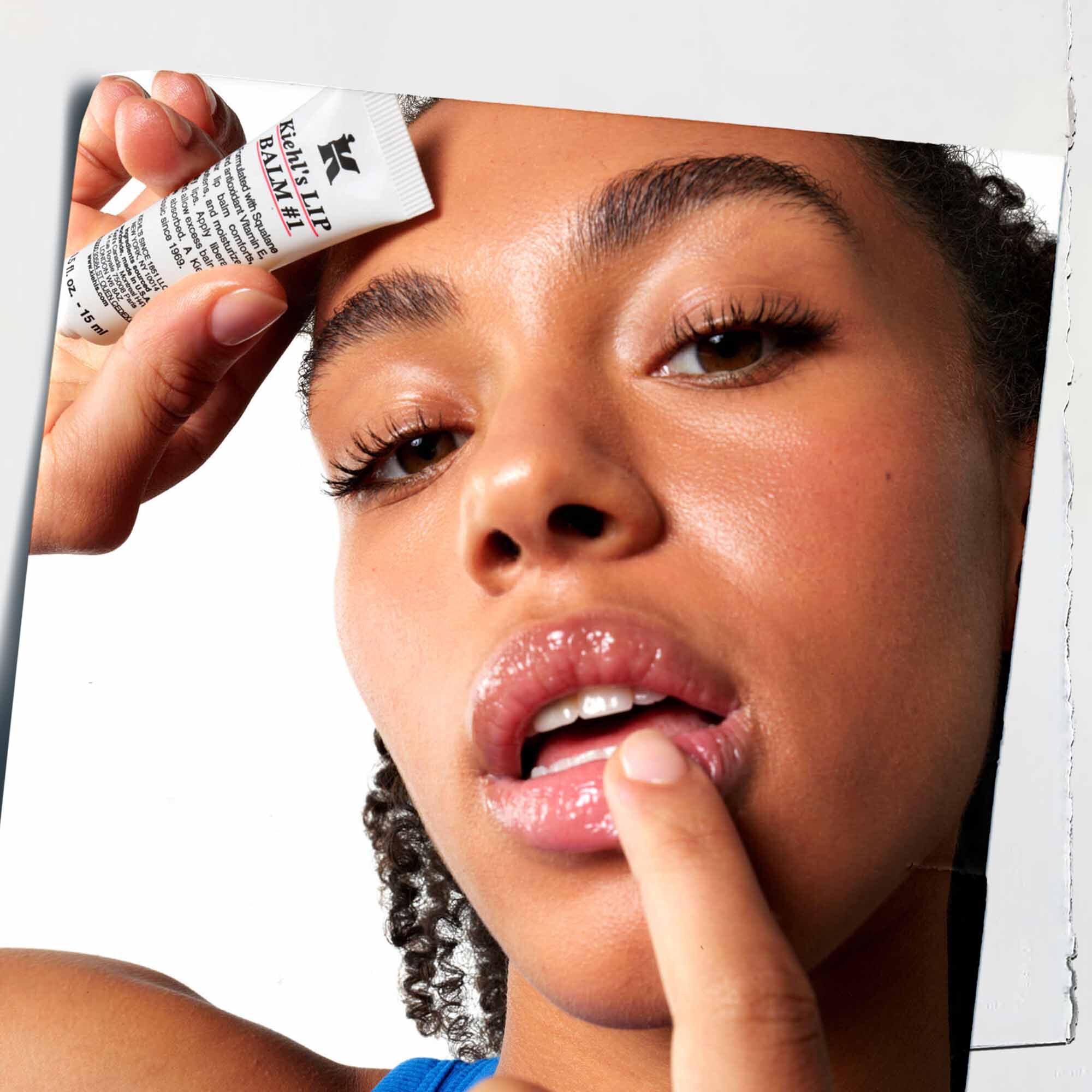 Lip Balm #1 being applied to lips, showcasing its use on skin.