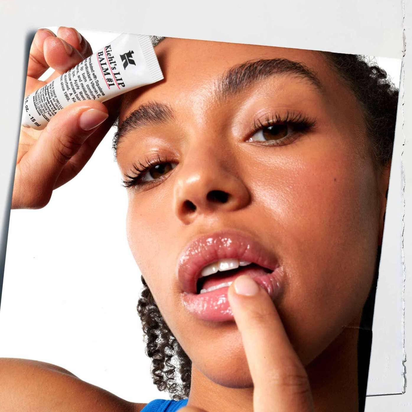 Lip Balm #1 being applied to lips, showcasing its use on skin.