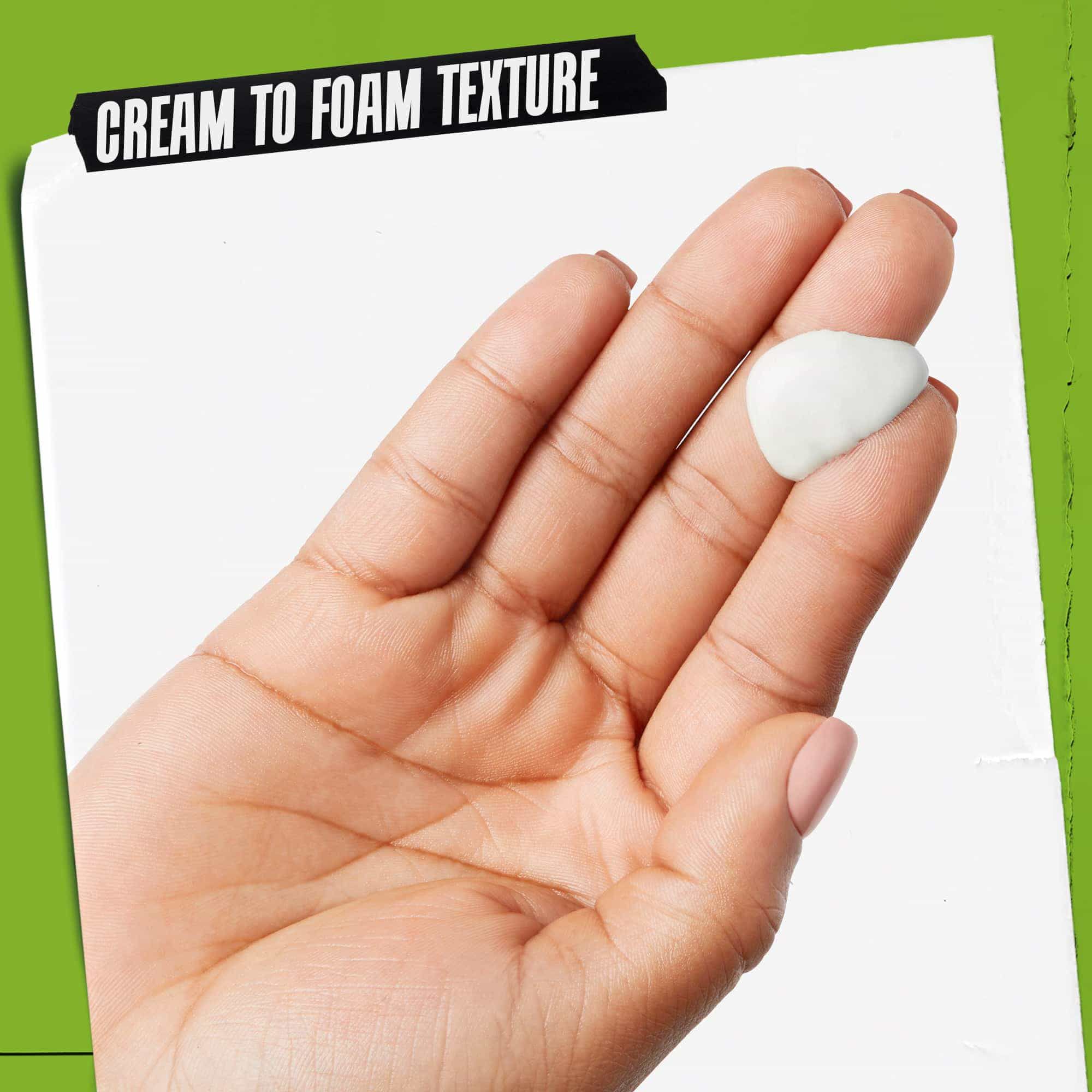 A person holding a tube of Rare Earth Deep Pore Daily Cleanser, showcasing its use