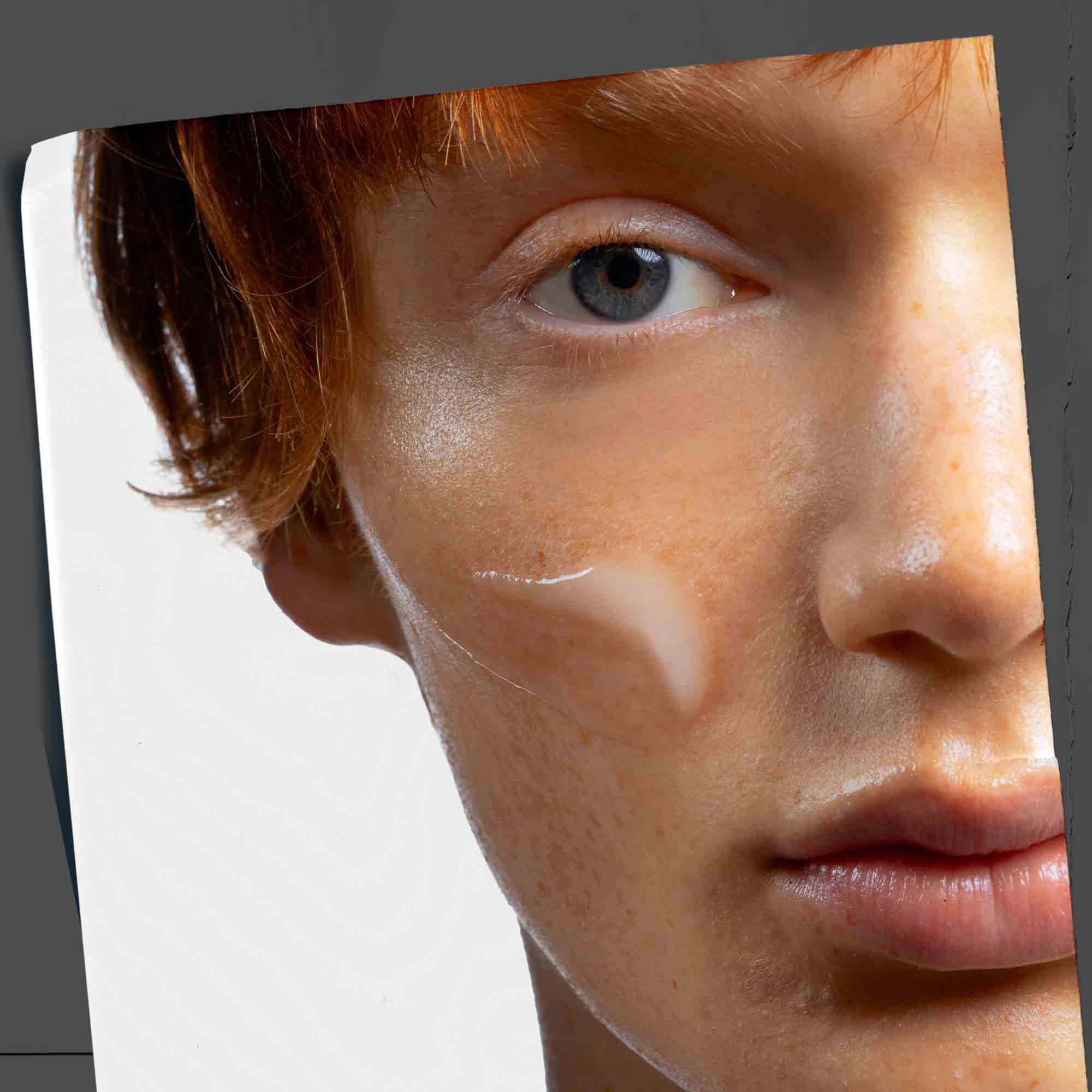 Age Defender Power Serum applied to the face, showcasing its lifestyle use.