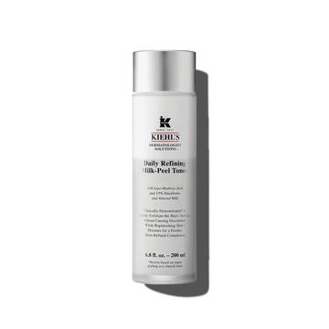 A graphic featuring a frosted bottle of Kiehl's Daily Refining Milk-Peel Toner with a silver cap and a label with black text. 