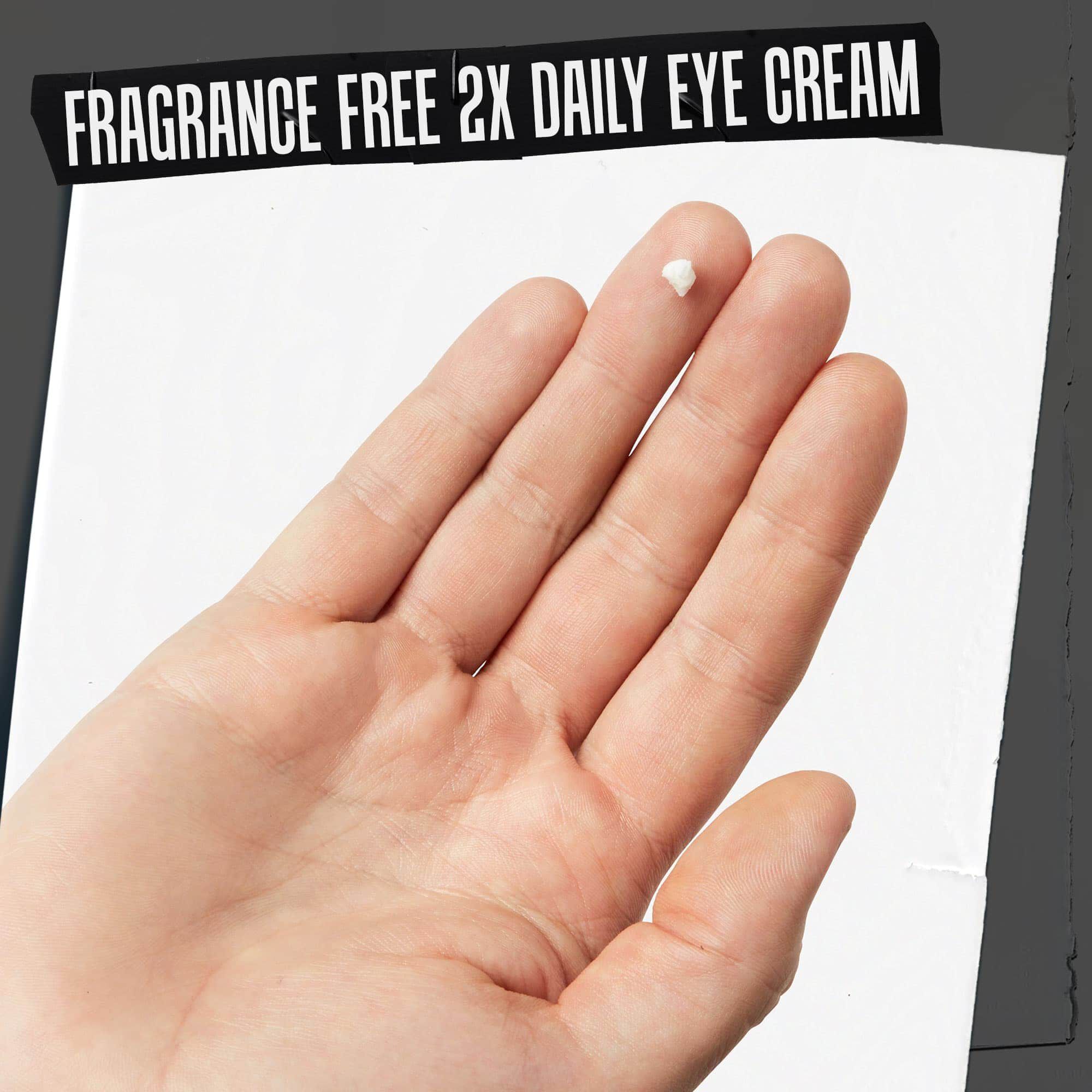 A hand holding Age Defender Eye Repair texture swipe labeled "Fragrance-Free 2x Daily Eye Cream."
