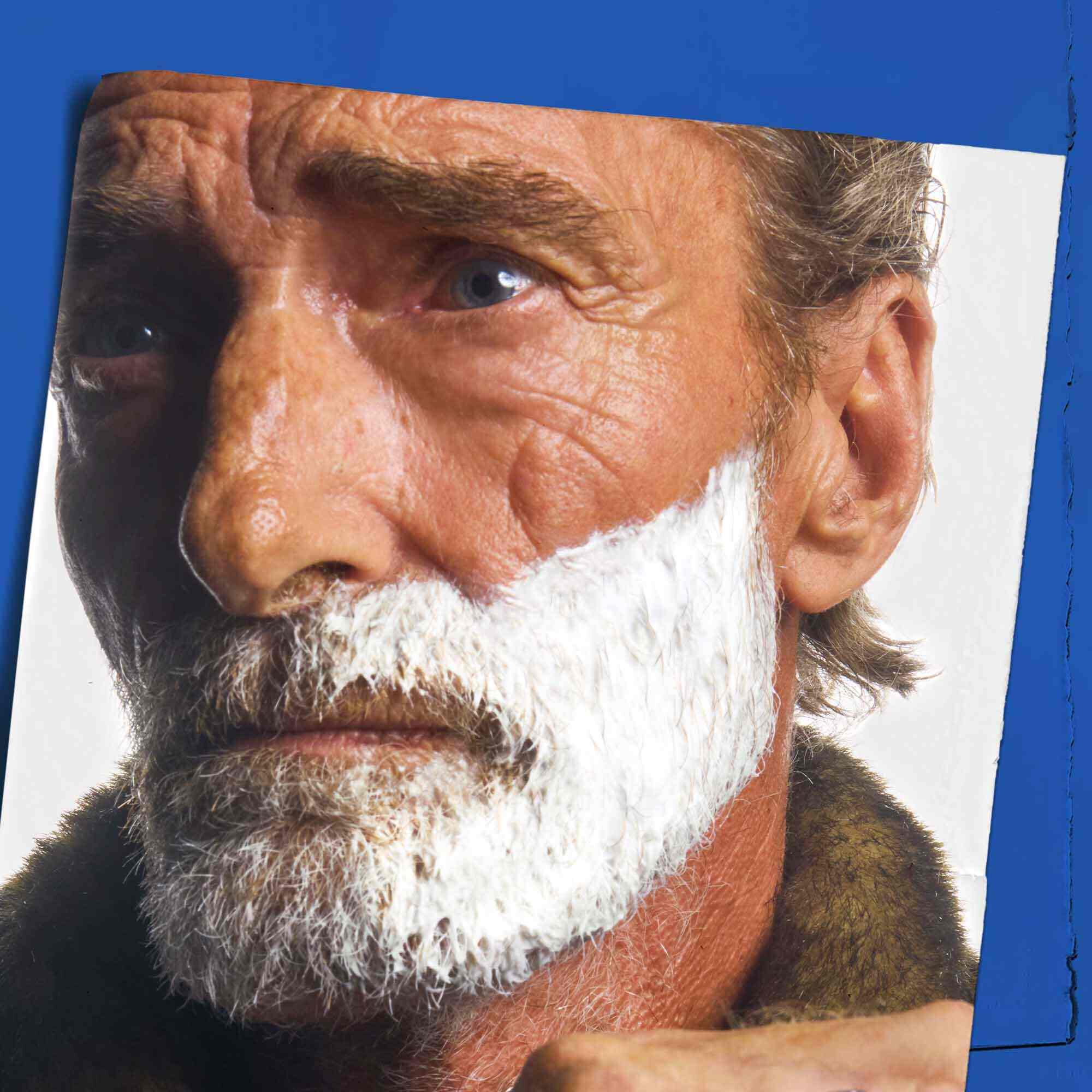 Ultimate Brushless Shave Cream White Eagle applied to a man's face, demonstrating its use for shaving.