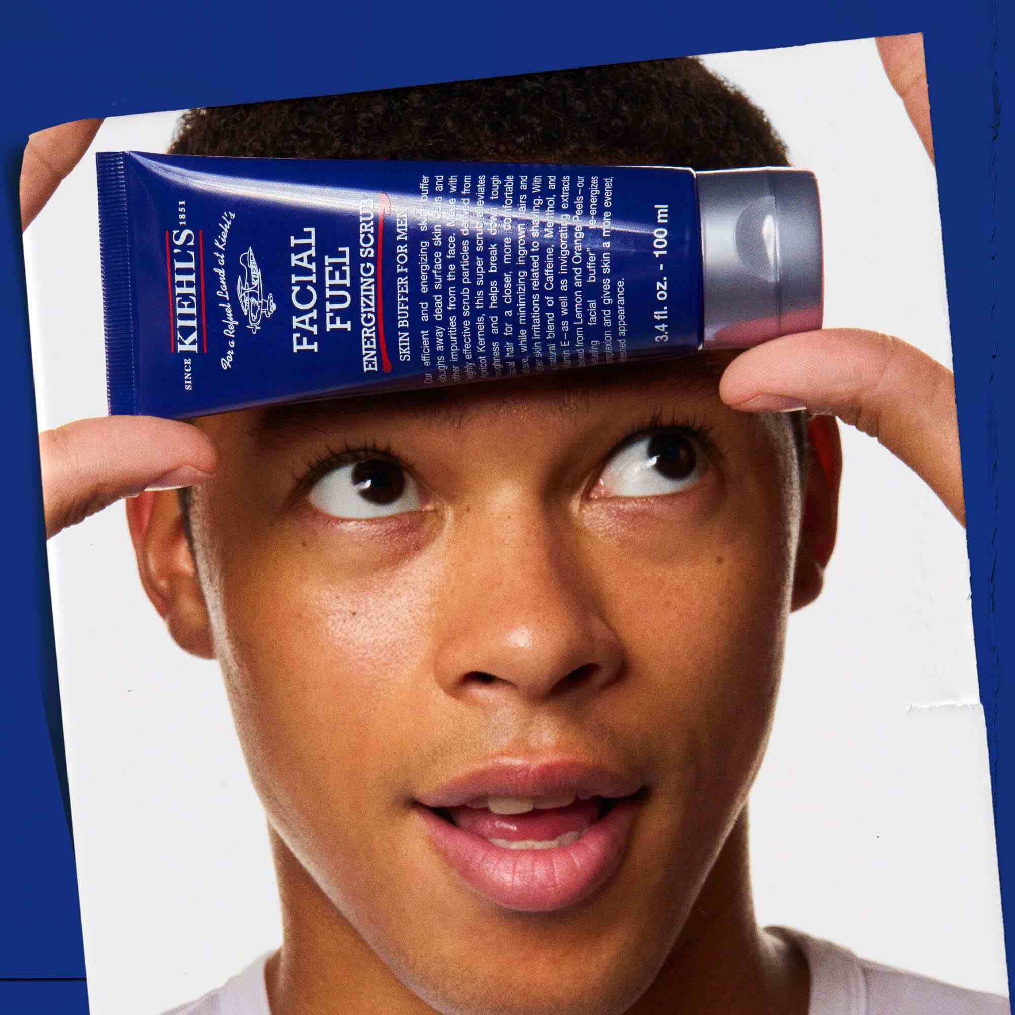 Facial Fuel Energizing Scrub being held, showcasing its use.