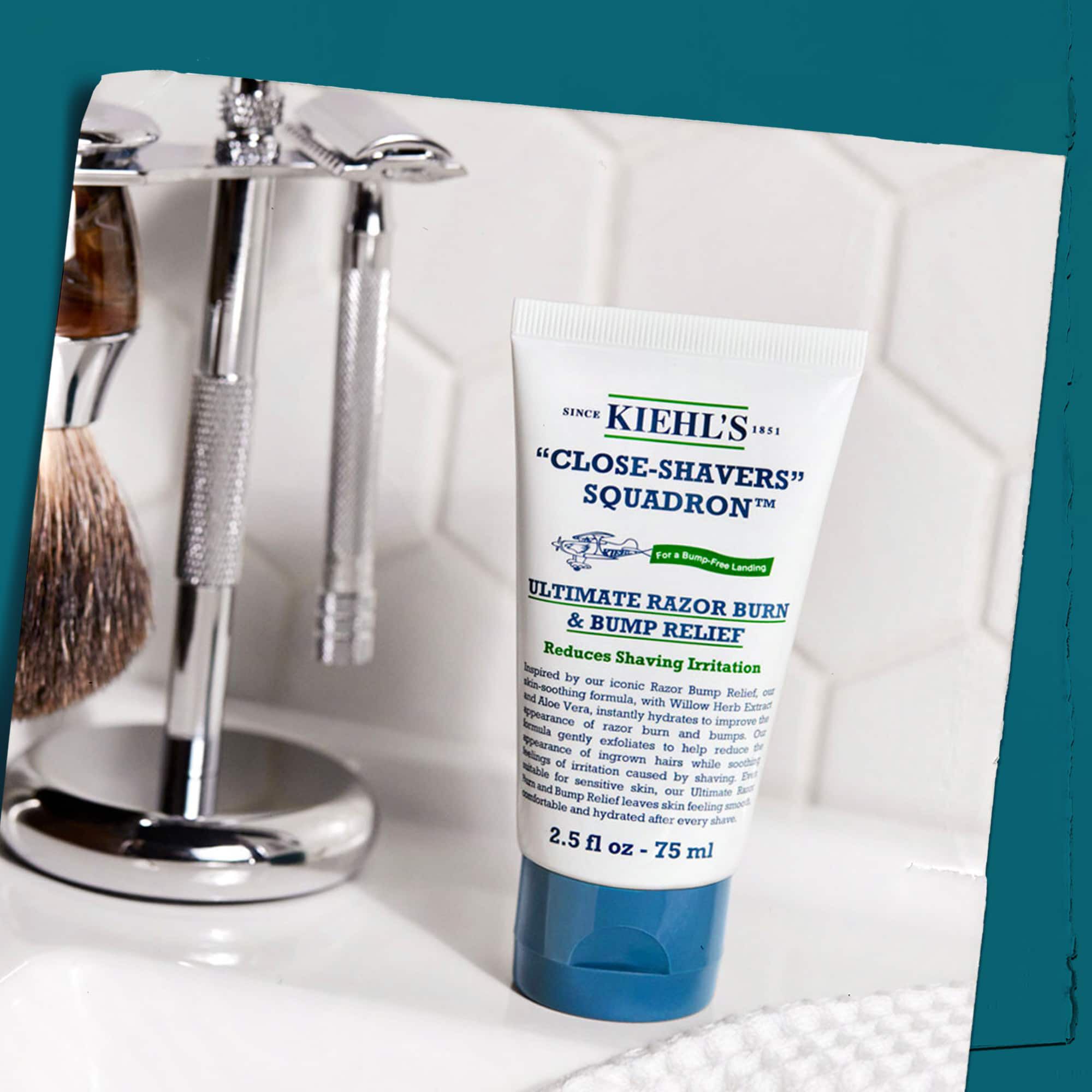Tube of Close Shavers Squadron Smooth Glider Precision Shave Lotion displayed with shaving tools, emphasizing its use in a shaving routine.