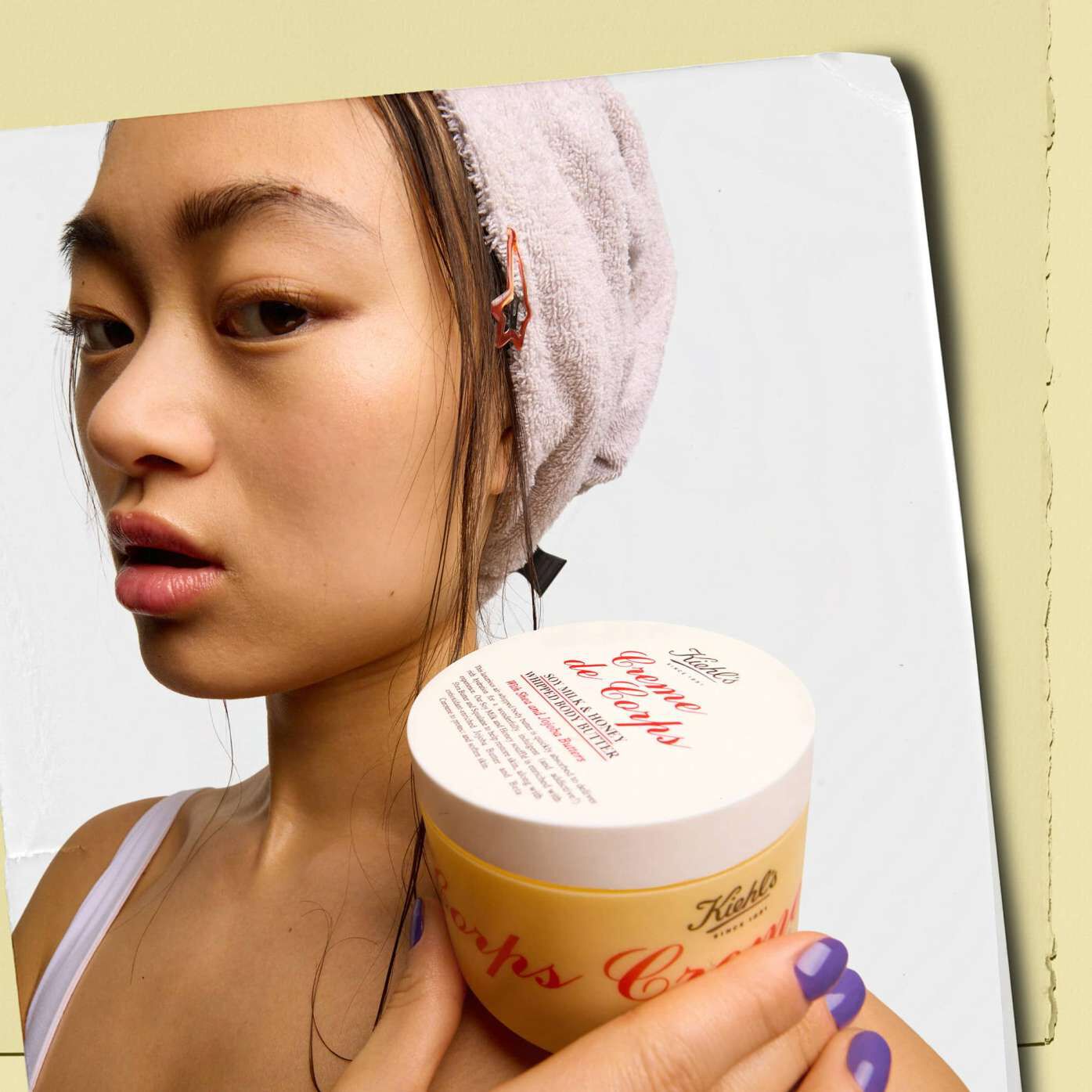 Model holding a jar of Kiehl's Creme de Corps Whipped Butter Body Butter