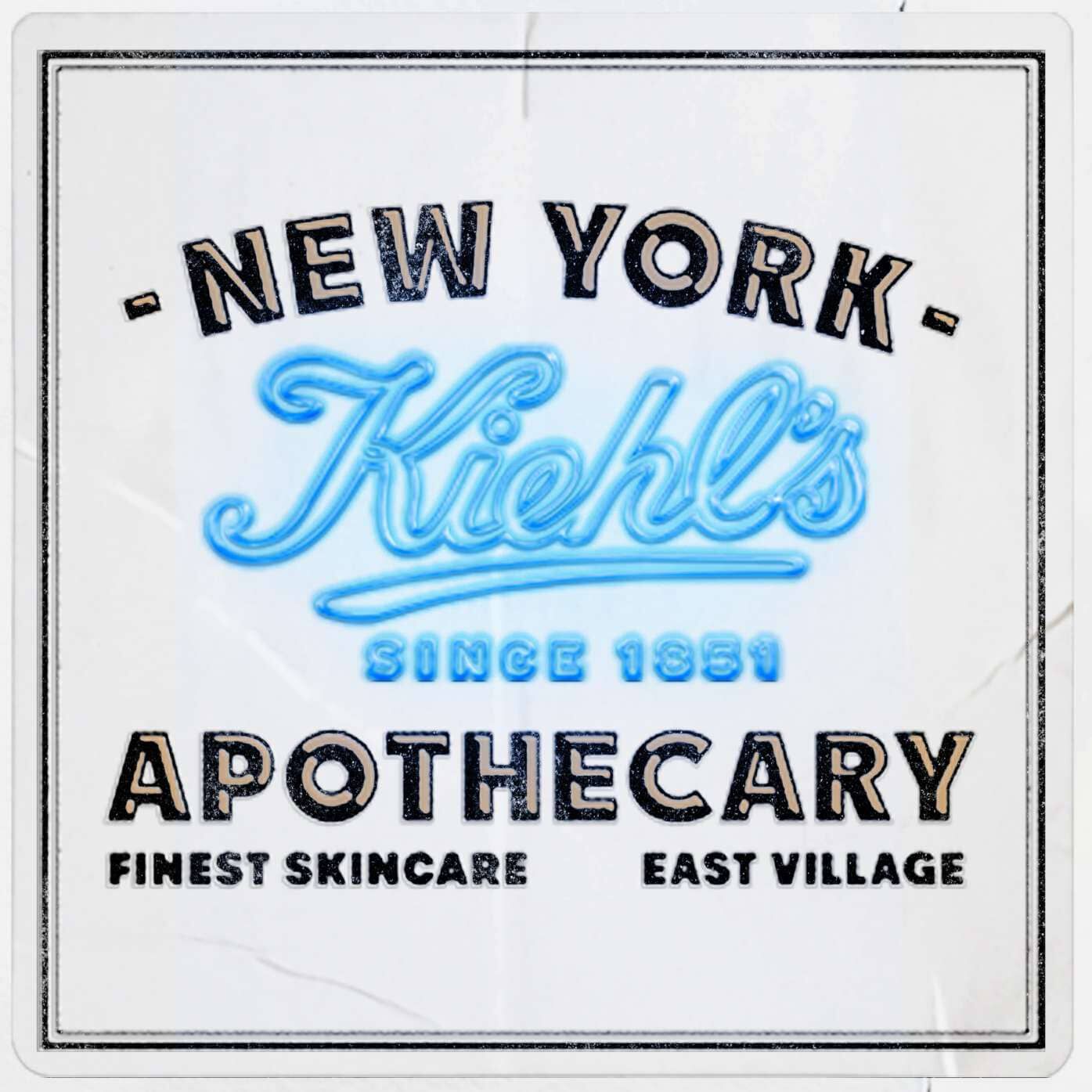  Kiehl’s Since 1851 apothecary label in New York’s East Village. Features the brand logo in blue neon style text on a white vintage background with the words "Finest Skincare."