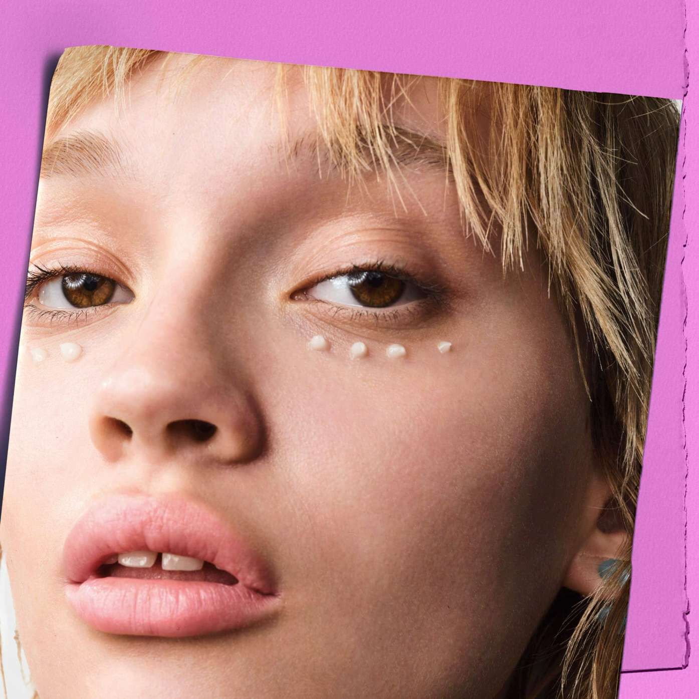 Model with dots of Kiehl's Super Multi-Corrective Eye Zone Treatment under their eyes