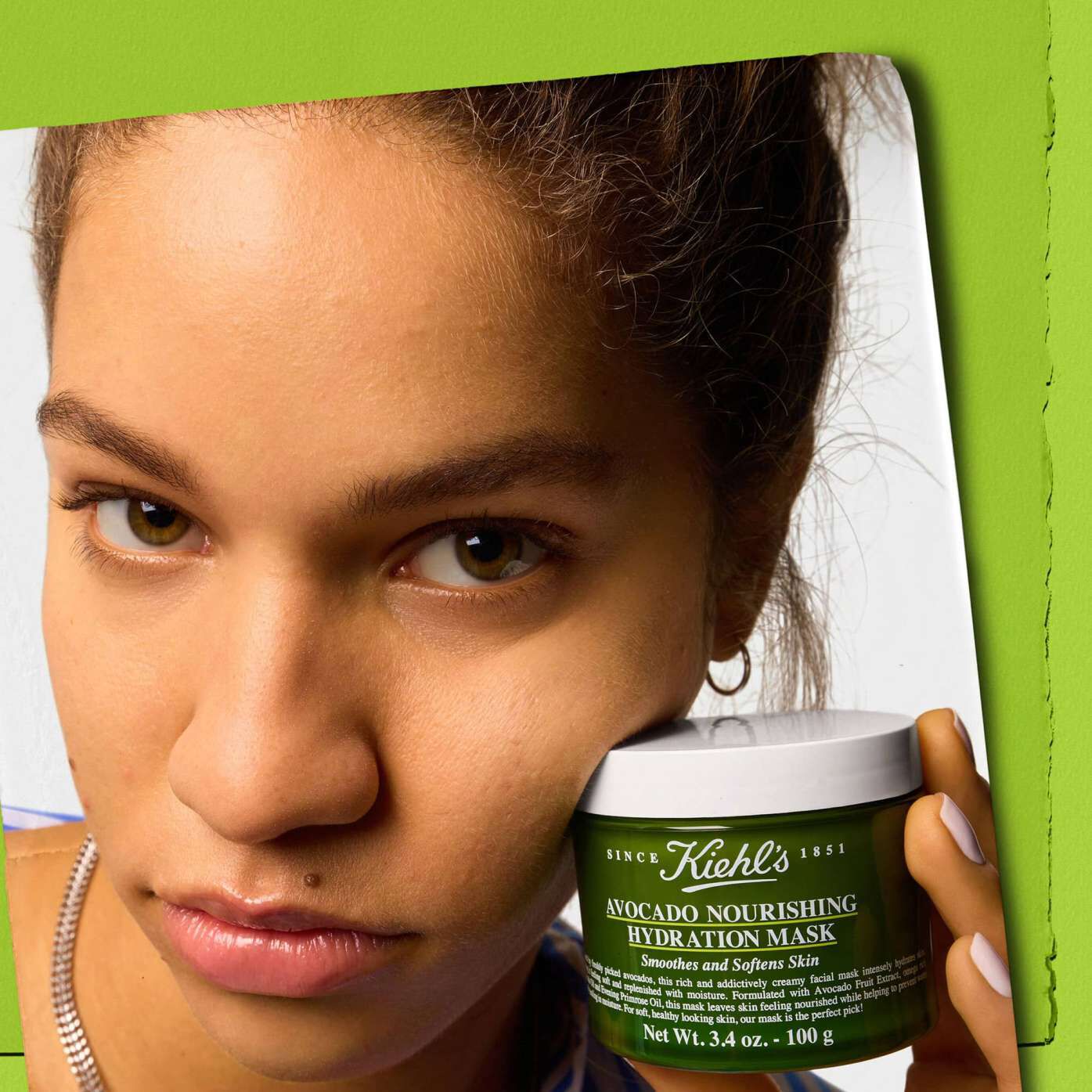 Model holding a jar of Kiehl's Avocado Nourishing Hydration Mask - Smoothes and Softens Skin