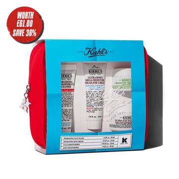 Kiehl's travel-sized skincare gift set in a red pouch, featuring multiple products visible through a blue-themed window.