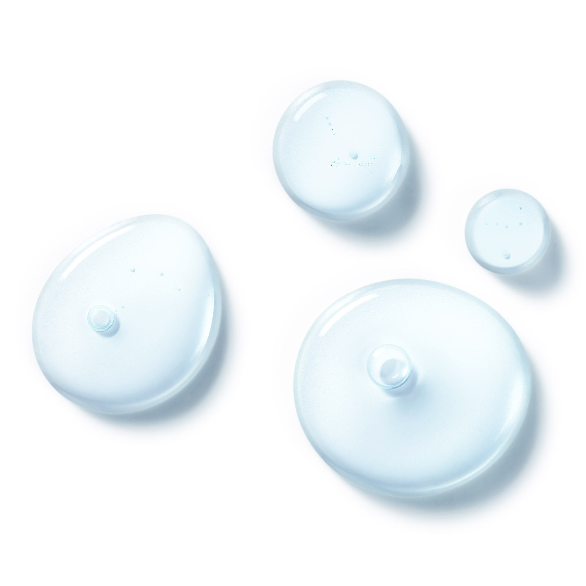 A close-up of the Clearly Corrective Triple Acid Peel texture showing clear liquid drops and bubbles.