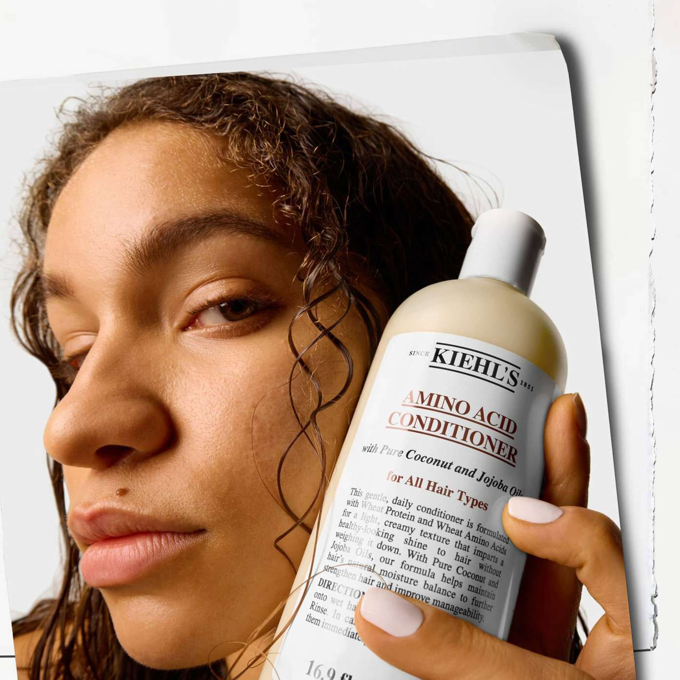 Model holding Kiehl's Amino Acid Conditioner