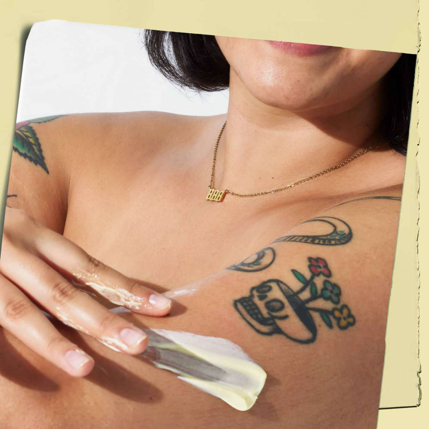 Tattooed model with Kiehl's Creme de Corps body lotion texture on their skin
