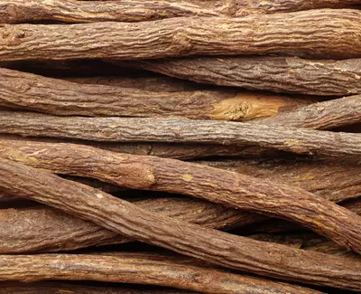 A close-up view of intertwined, textured sticks or roots, showing various shades of brown and a natural, rustic appearance.