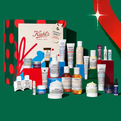 Kiehl’s holiday advent calendar and skincare gift set featuring assorted creams, serums, cleansers, and treatments on a festive display.