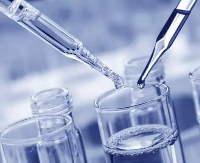 Two pipettes are poised above glass test tubes containing clear liquid, with water droplets ready to be released. The image has a cool blue tint.