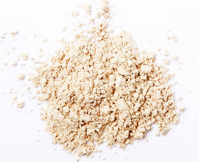 A small mound of light beige powder on a white background.