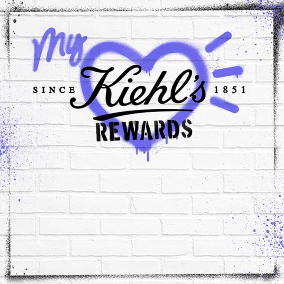 Graphic featuring the text "My Kiehl's Rewards" over a heart design, with "Since 1851" at the bottom, against a textured white brick background. The text is styled in a mix of black and purple colors.