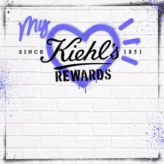 Graphic featuring the text "My Kiehl's Rewards" over a heart design, with "Since 1851" at the bottom, against a textured white brick background. The text is styled in a mix of black and purple colors.