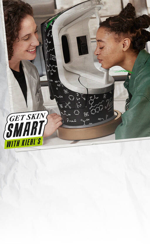 A skincare professional and a customer interact by a high-tech device at a Kiehl's store, with the device displaying chemical structures on its exterior.