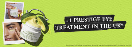 Jar of Kiehl's Creamy Eye Treatment with avocado slices and text "#1 Prestige Eye Cream in the UK" on a green background.