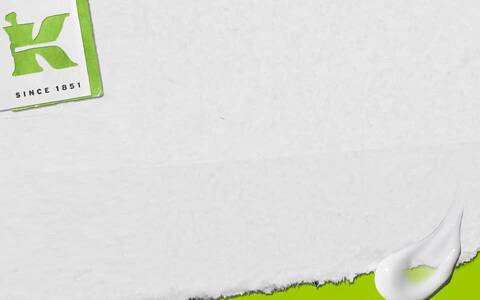 Alt text: A textured background with green accents featuring the letter "K" in a bold font and the phrase "Since 1851" in a smaller size, accompanied by a white droplet shape.