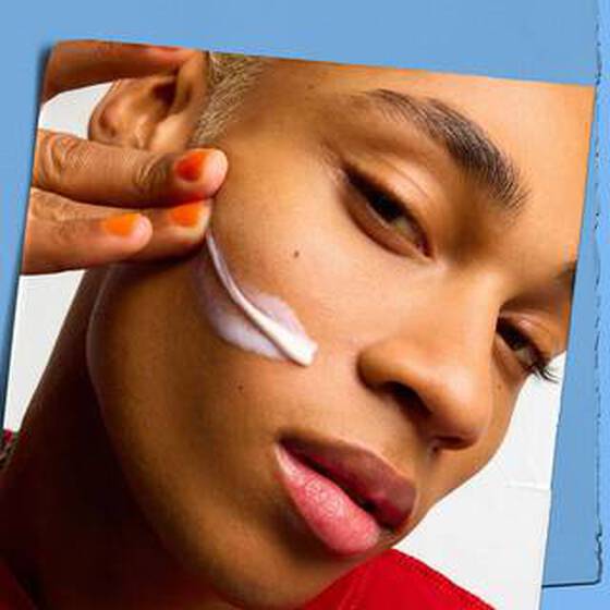 young woman applying a skincare product with ceramides to her face