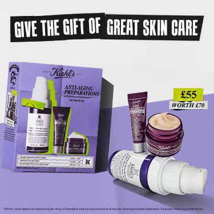An image featuring a Kiehl's "Anti-Aging Preparations" gift set for face and eyes. The set, priced at £55 (worth £70.23), is presented in a purple box and includes three products: Retinol Skin-Renewing Daily Micro-Dose Serum (30ml), Super Multi-Corrective Eye Zone Treatment (5ml), and Super Multi-Corrective Cream (7ml). The products are displayed both on the box's packaging and as physical items in the foreground. At the top, a bold banner reads "GIFT THE GIFT OF GREAT SKIN CARE."